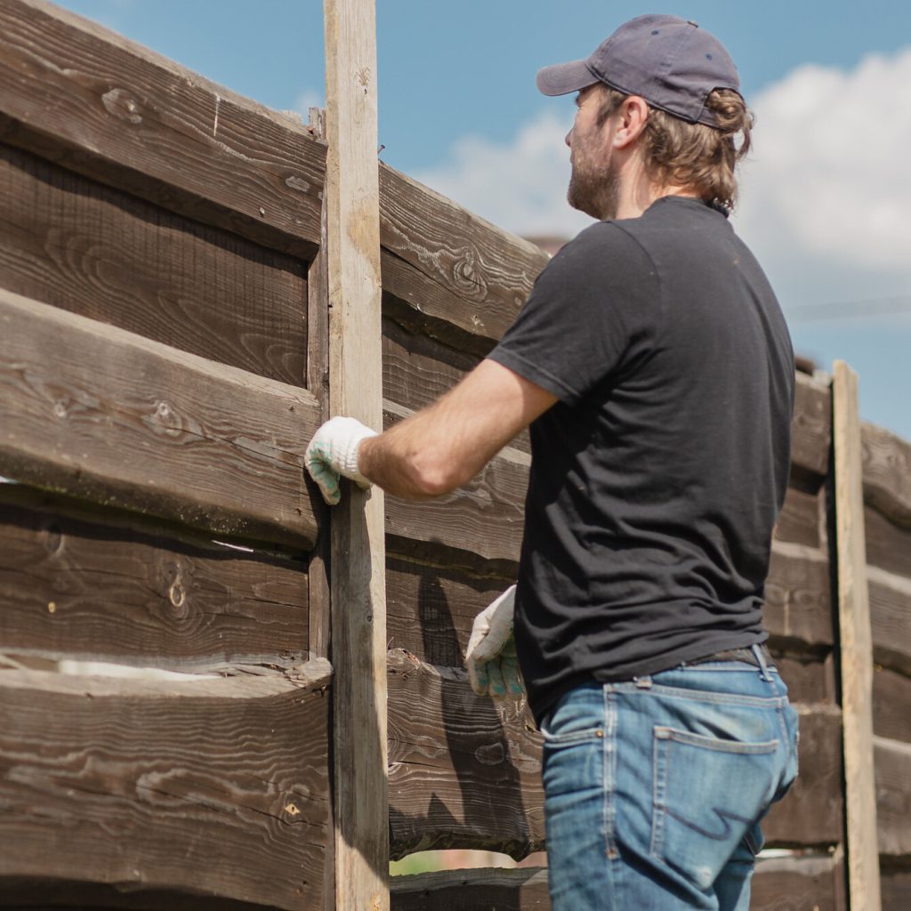 Contractor installs a fence.